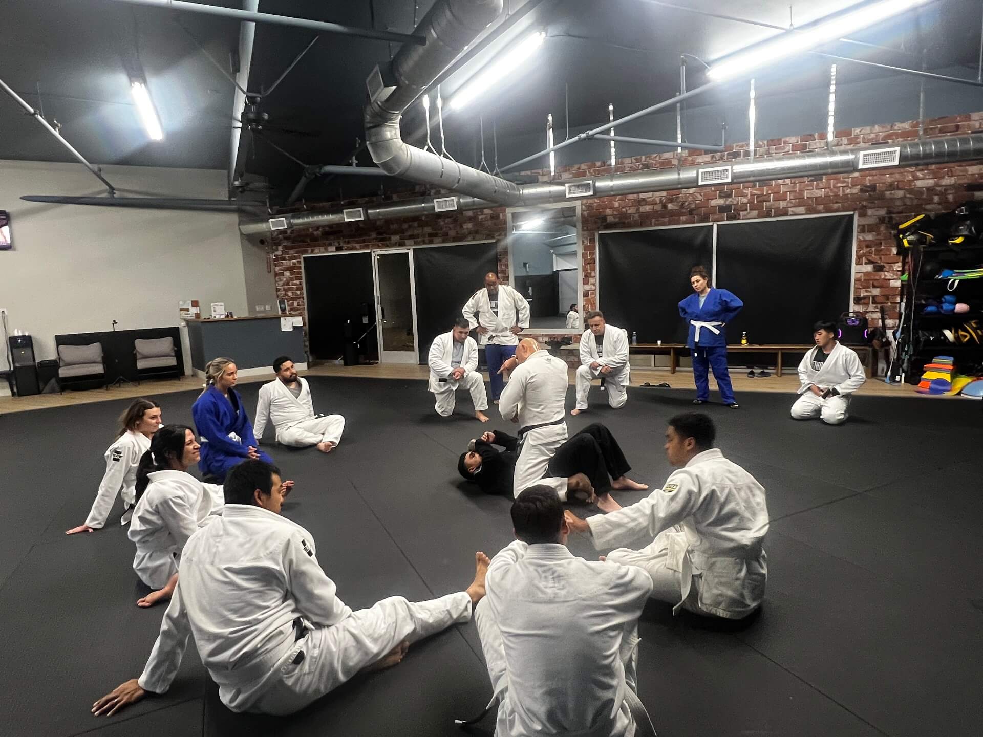 Adults rolling in a Brazilian Jiu Jitsu class at Manifest MMA